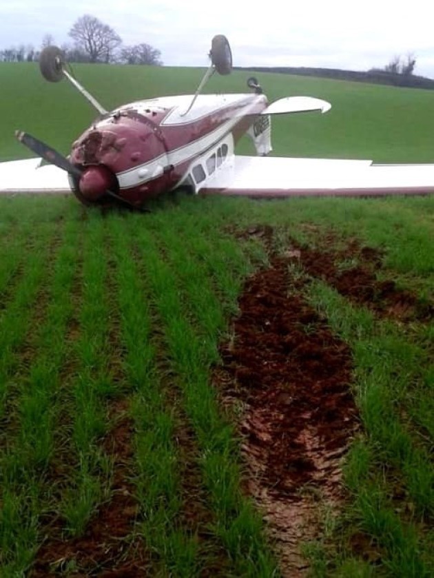 upside down plane in a field