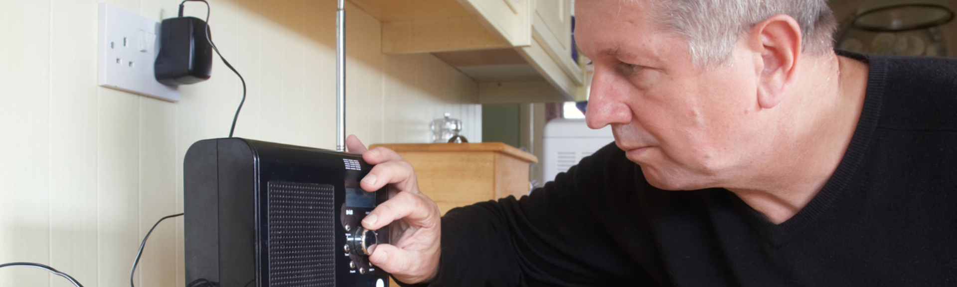 Man tuning DAB radio