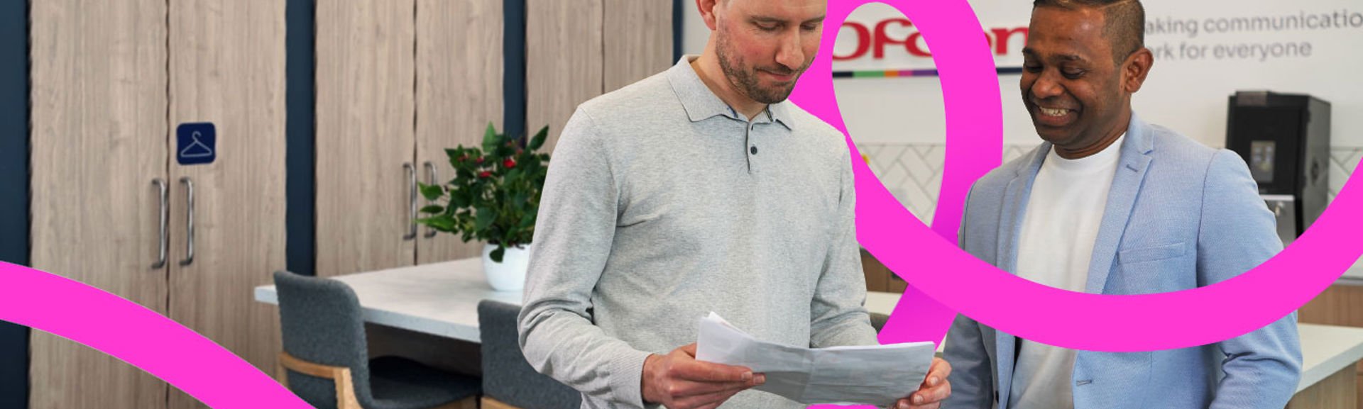 Two Ofcom colleagues discussing their work