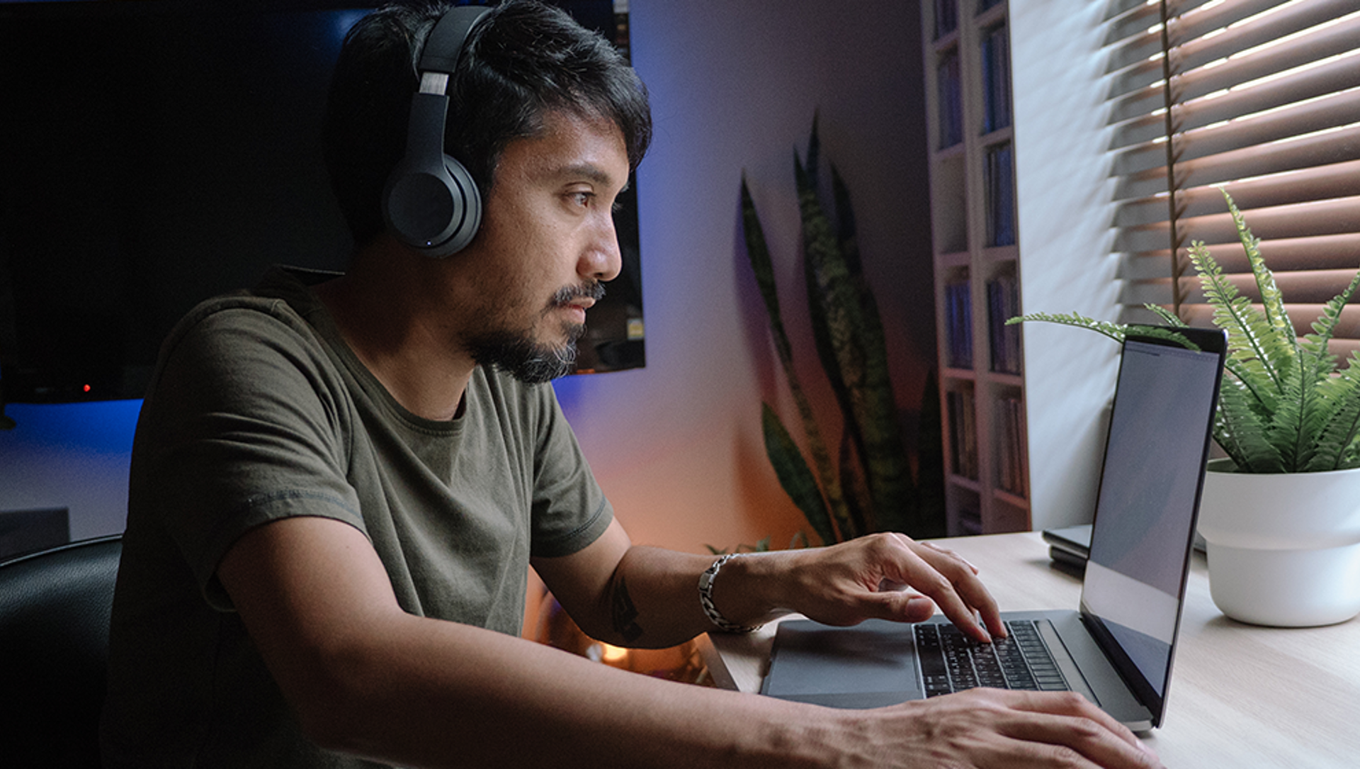 Man on laptop wearing headphones