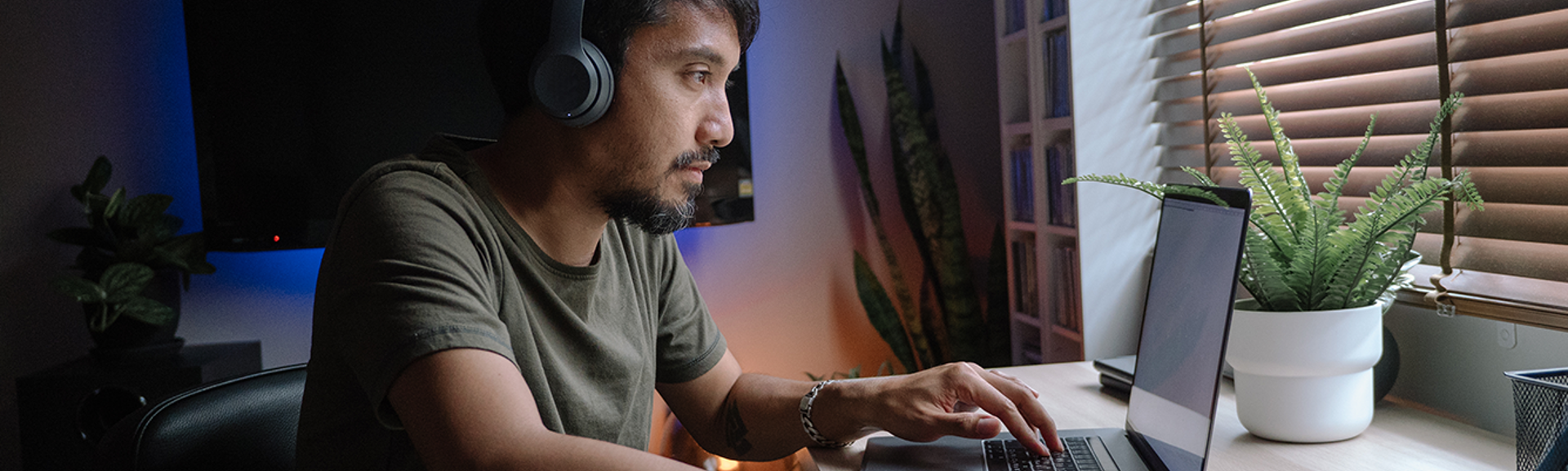 Man on laptop wearing headphones