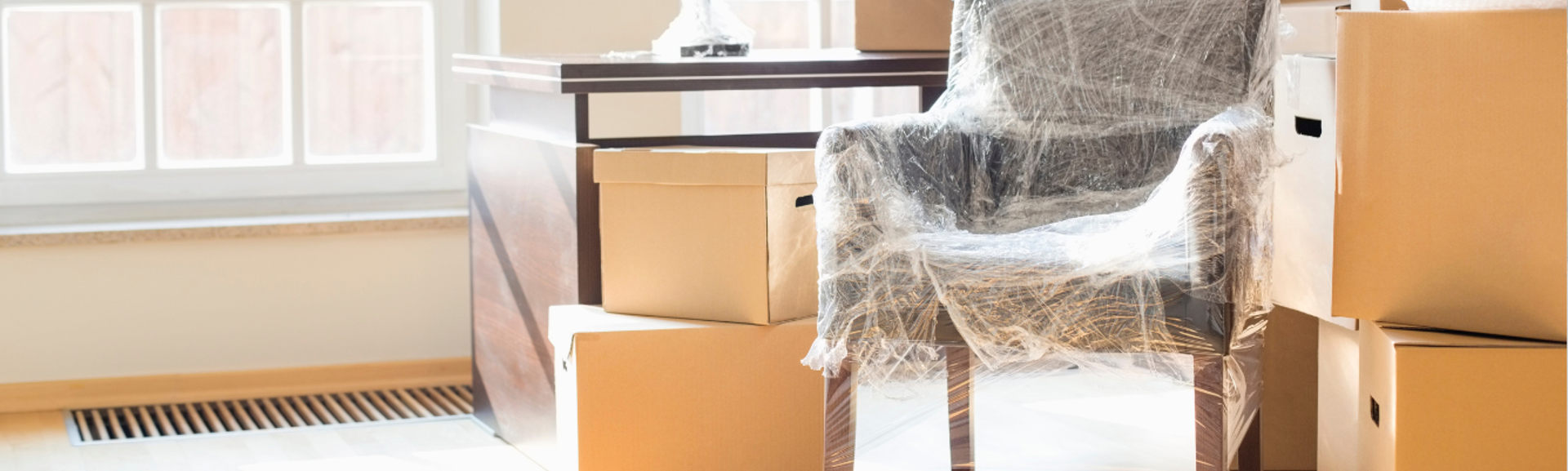 A stack of cardboard boxes and furniture packed for removal