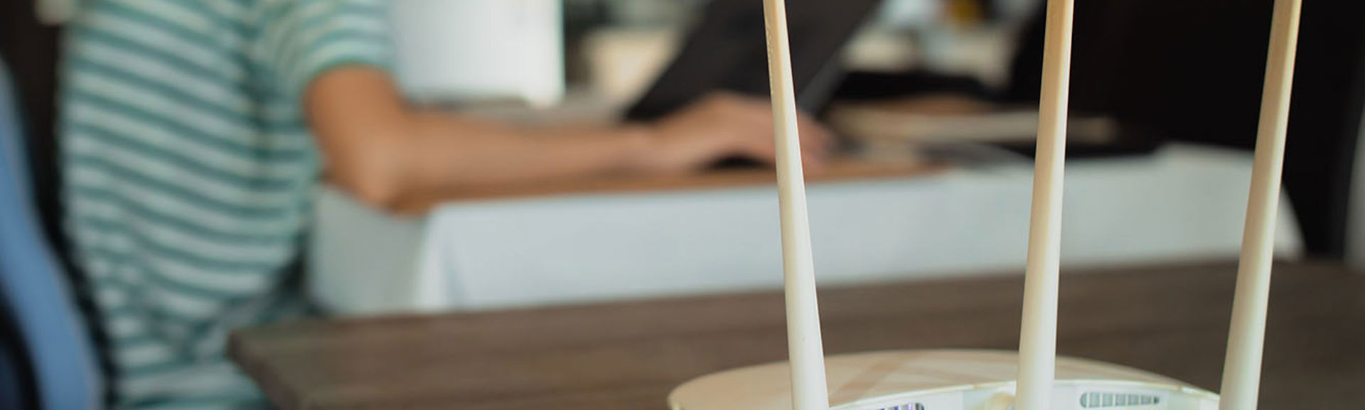 The rear of a wireless router on a table in a family home