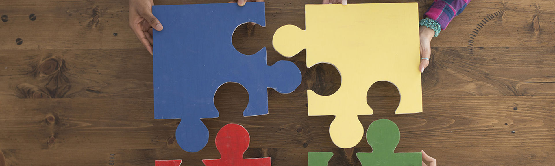 Four abstract jigsaw pieces being put together