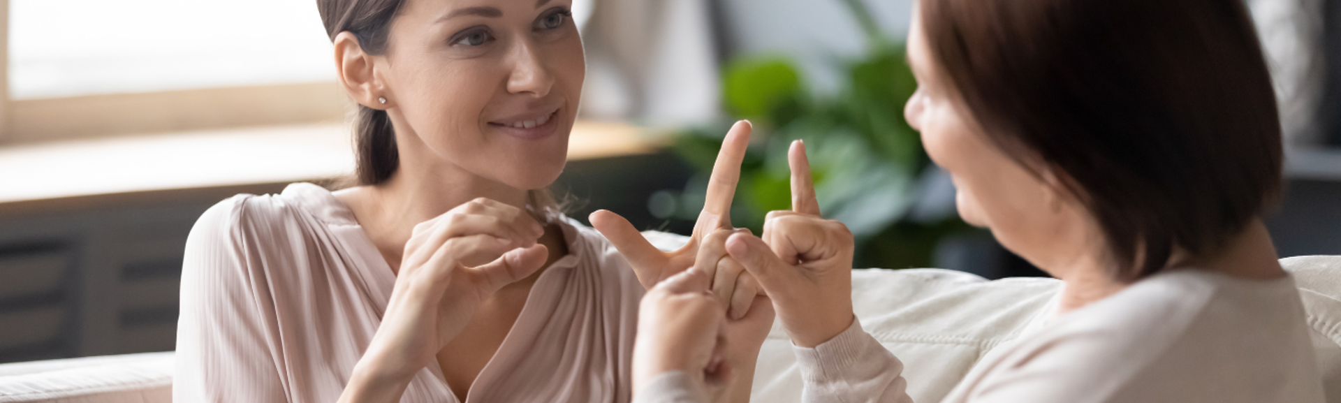 Two women speaking to each other using sign language