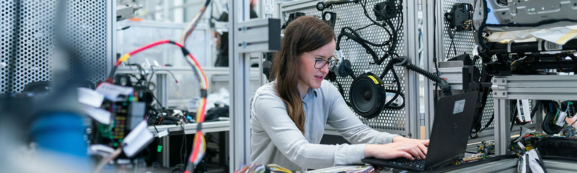 A female engineer working with equipment using a laptop