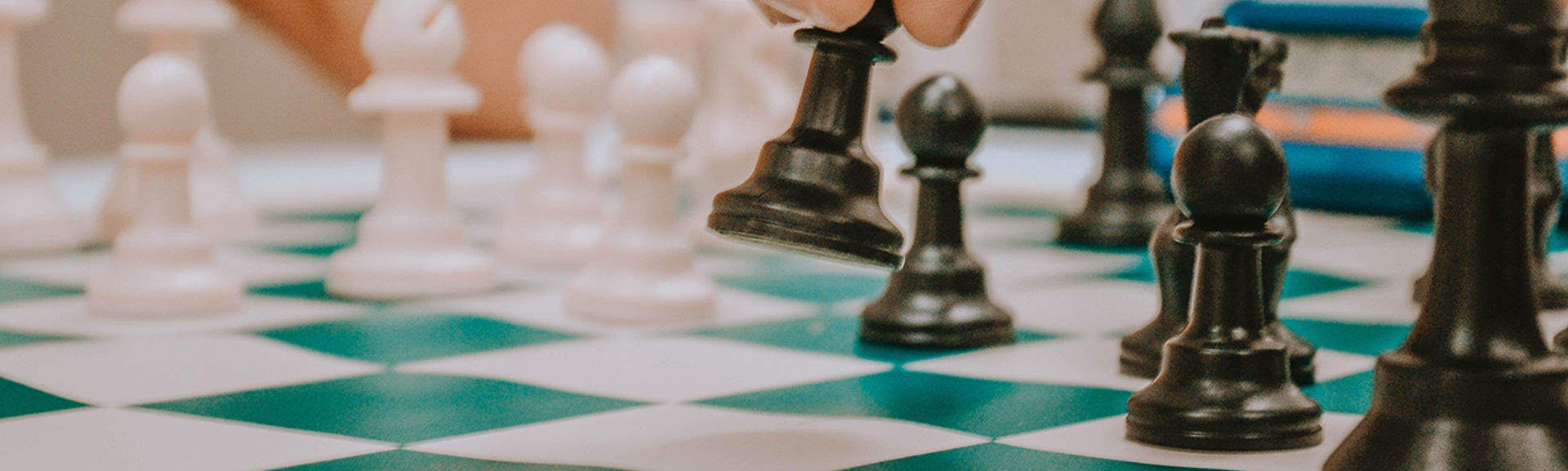 Someone moving chess pieces on a chess board