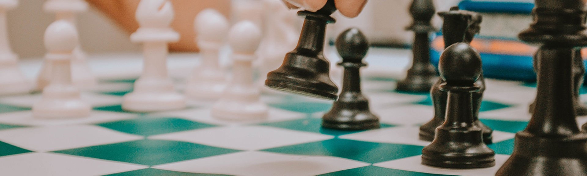 Someone moving chess pieces on a chess board