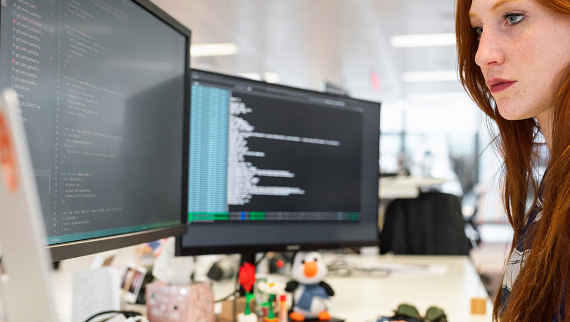 A woman coding on a computer