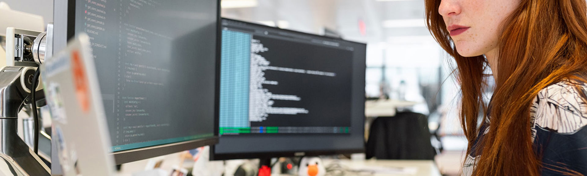 A woman coding on a computer