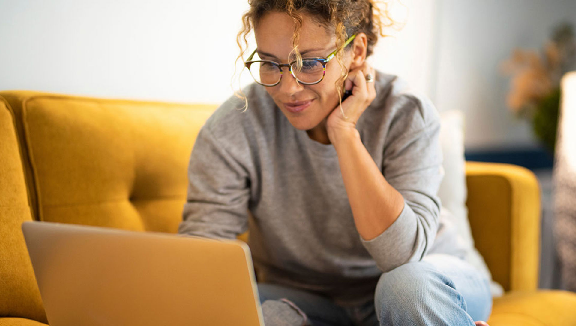 Woman in home setting using laptop
