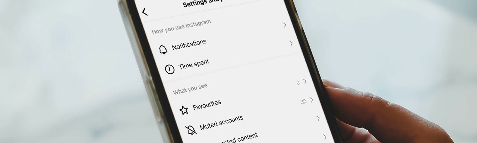 A close-up photo of a 'settings and privacy' screen on a mobile phone
