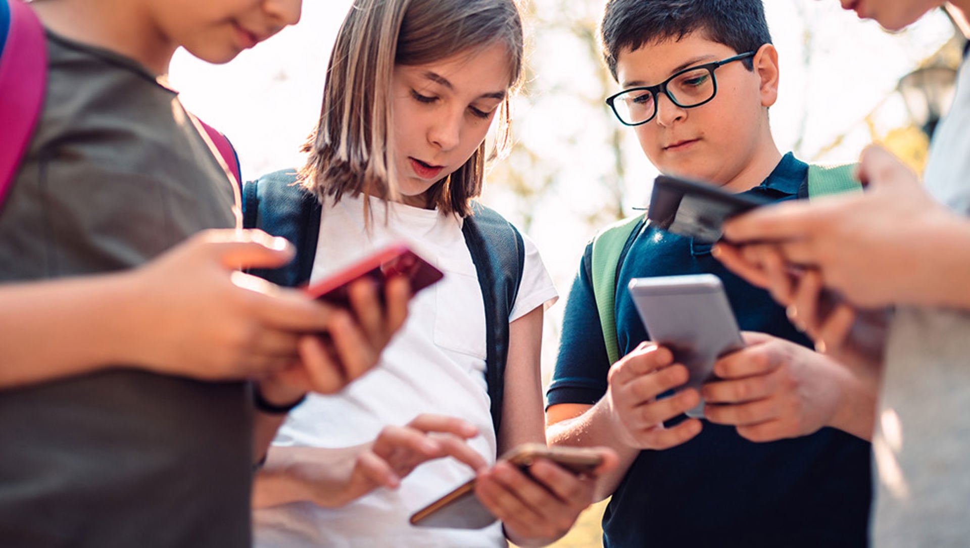 Kids playing video games on phone after school