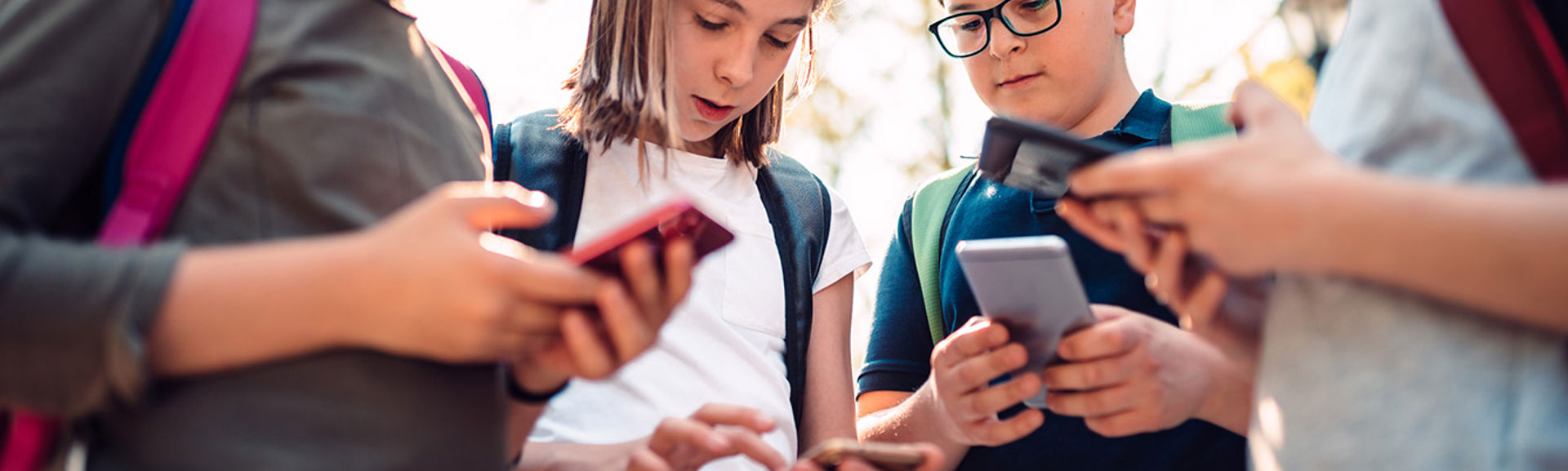 Kids playing video games on phone after school