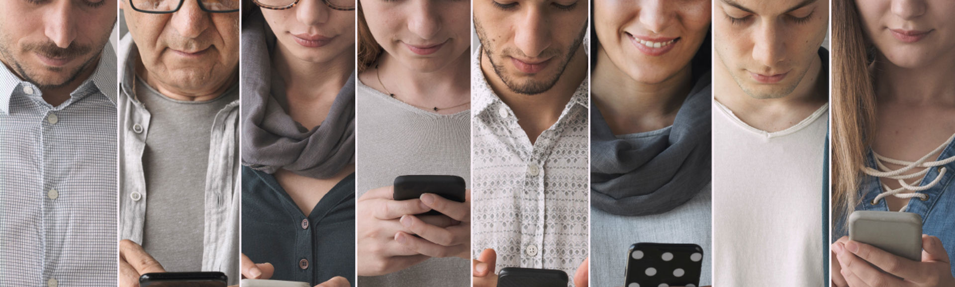 A mixture of people of different ages looking at their mobile phones, each with a different expression on their face.