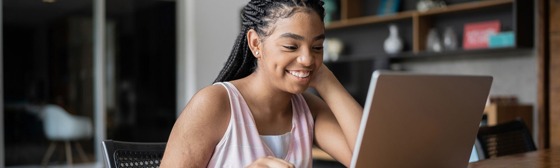 Teenage girl at desk on computer