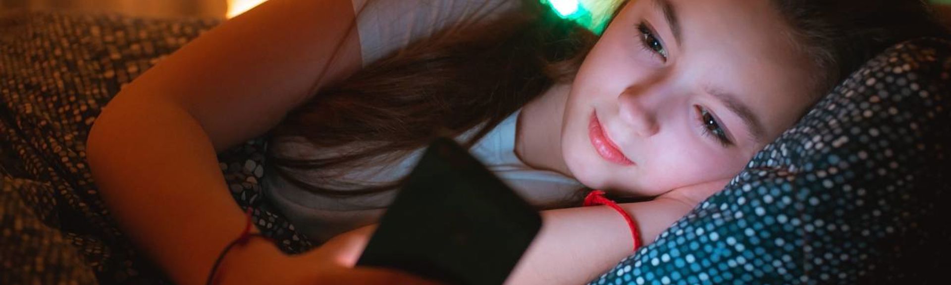 Young girl using mobile at night web