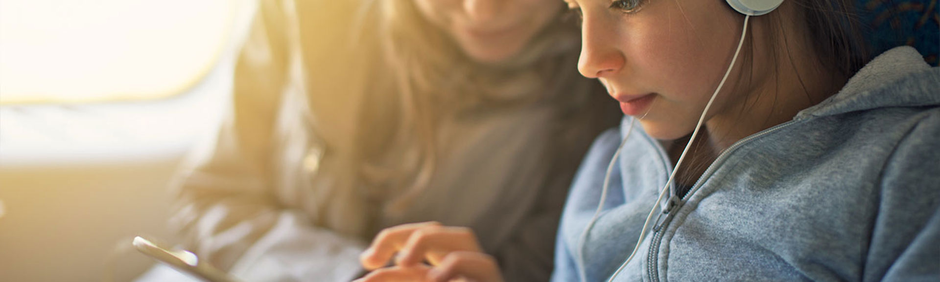 Mother and daughter using tablet device