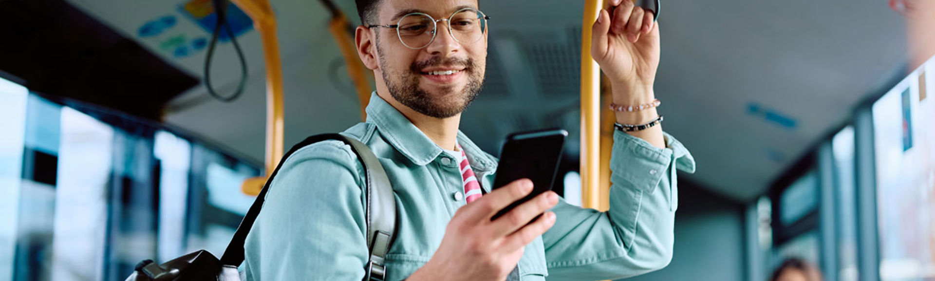 Man using his mobile phone on the bus
