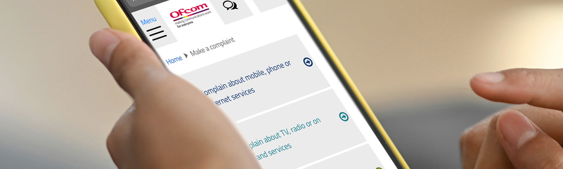 Woman complaining via the Ofcom website on her phone