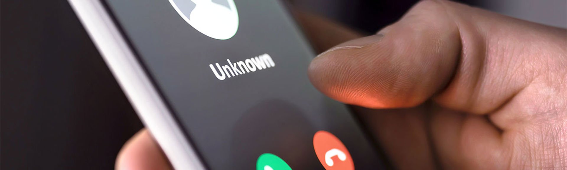 A close-up of a mobile phone with an unknown number calling