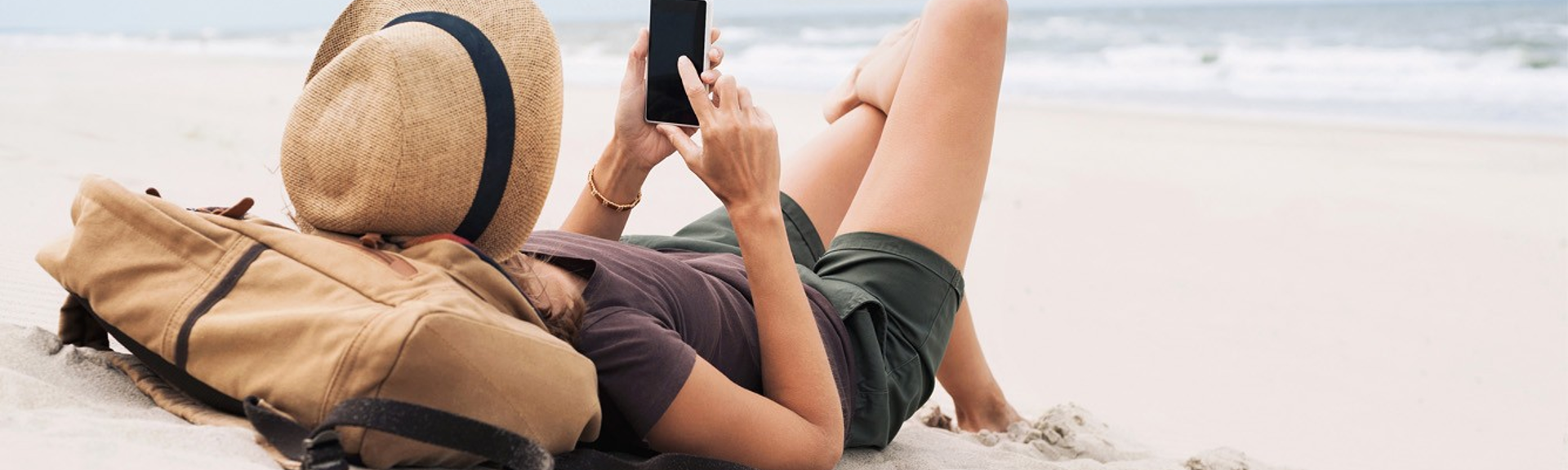 Woman-on-beach-using-smartphone-web