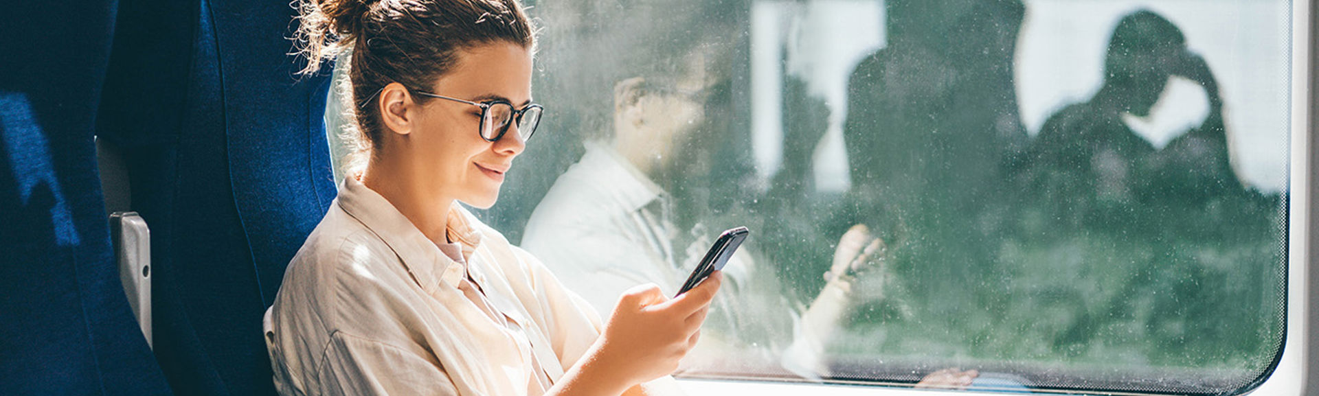 Young woman using s phone on the train