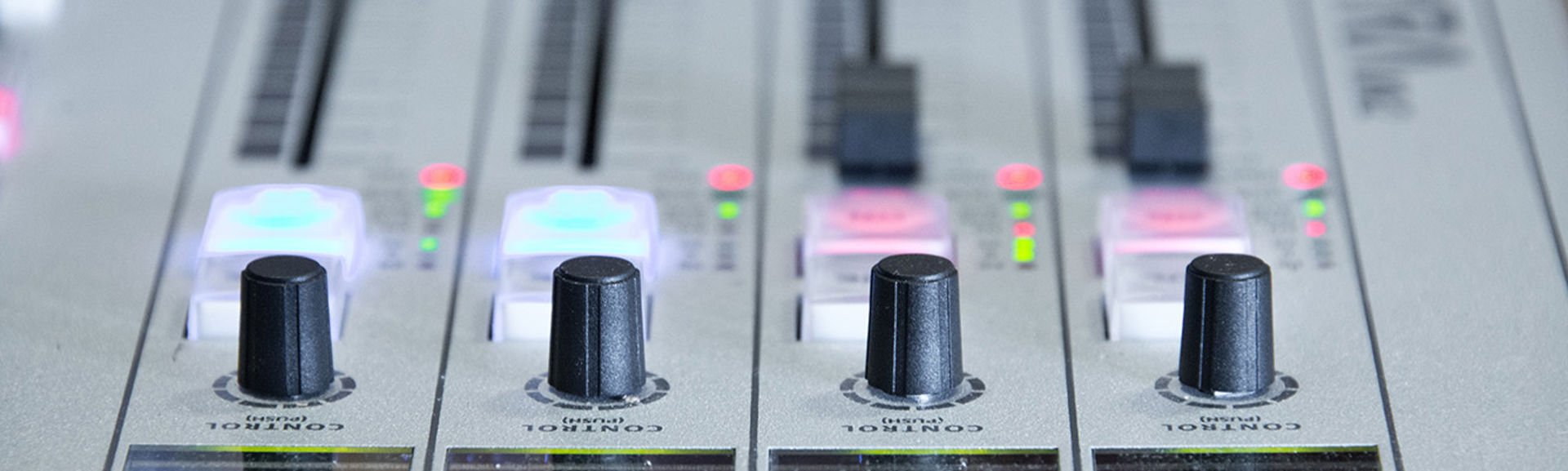 Close up of faders on a broadcast radio desk