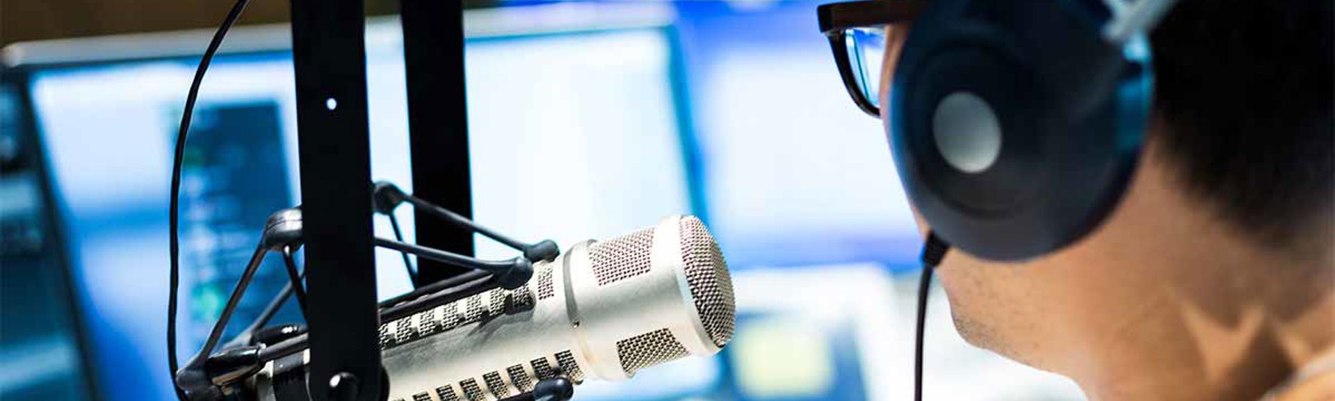 A person talking into a studio microphone