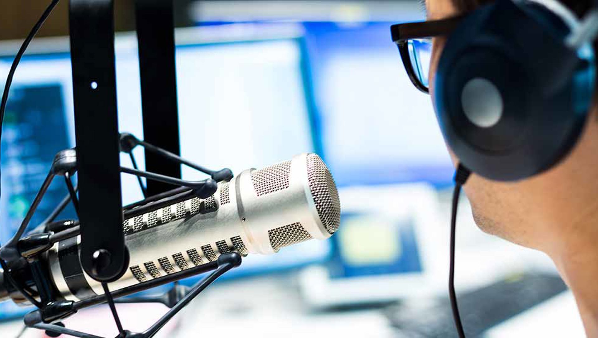 A person talking into a studio microphone