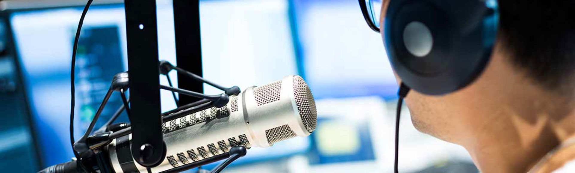A person talking into a studio microphone