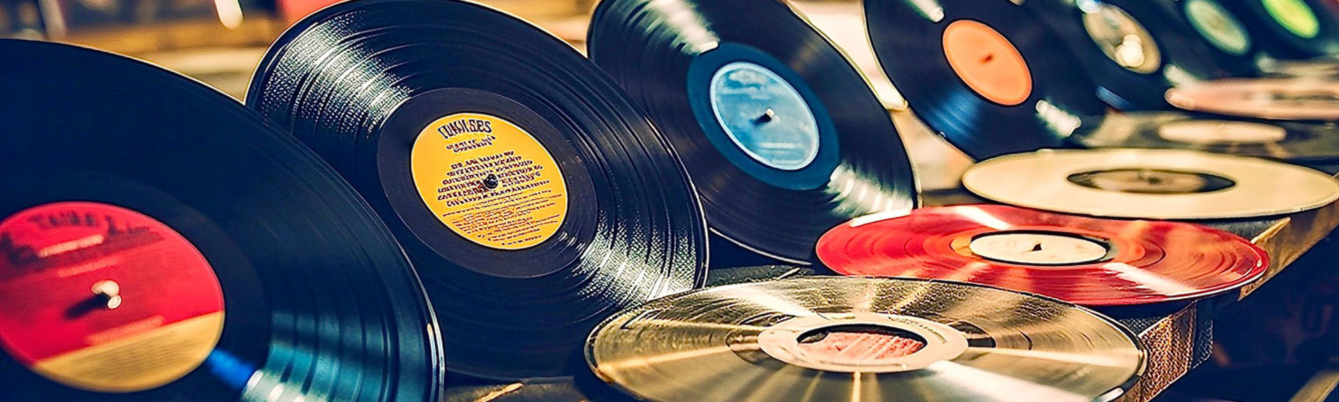 Vintage vinyl records and CDs on shelf in music shop. 