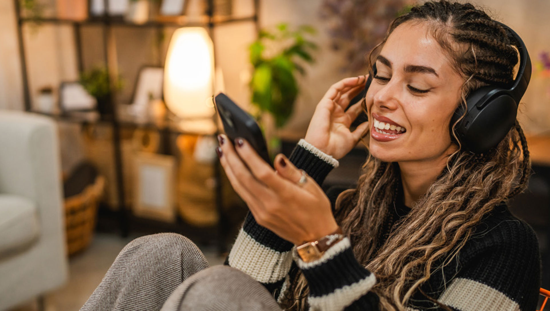 young woman with headphones on mobile_web