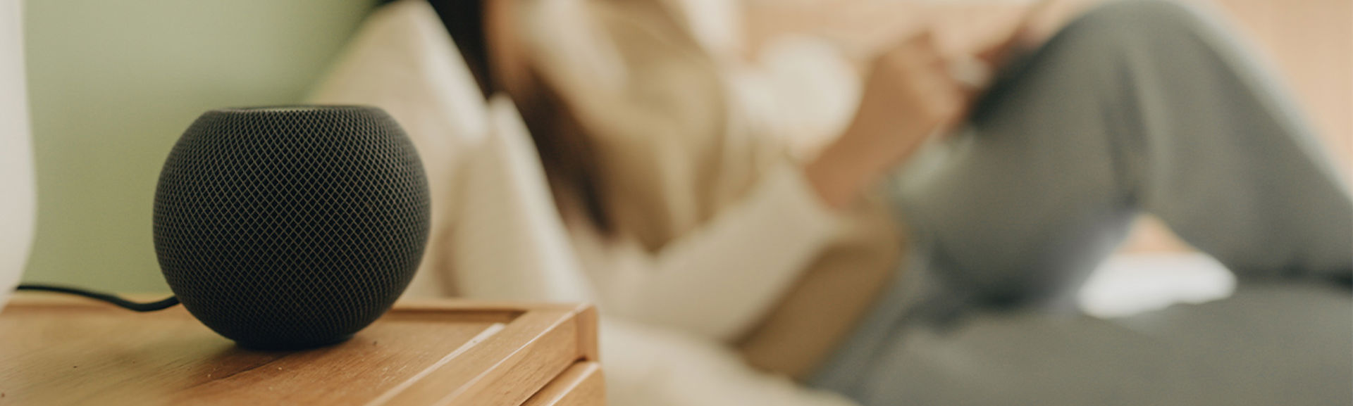 Smart speaker with woman in background