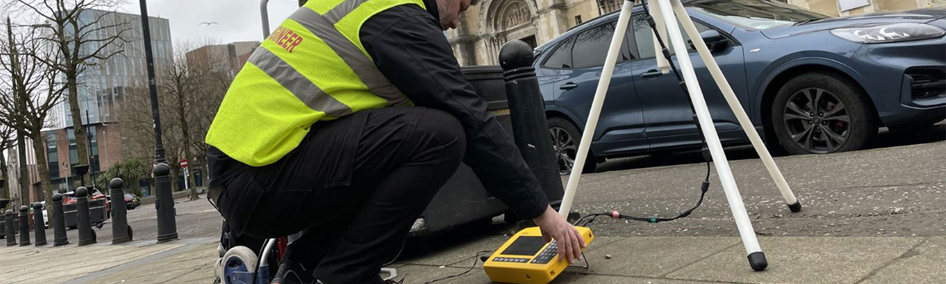 An engineer wearing a hi-vis vest assessing 5G frequencies