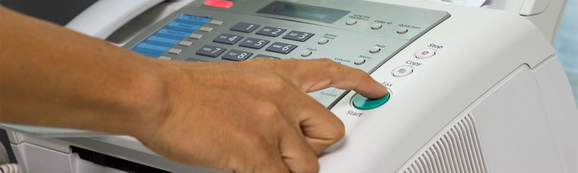 Someone using a fax machine