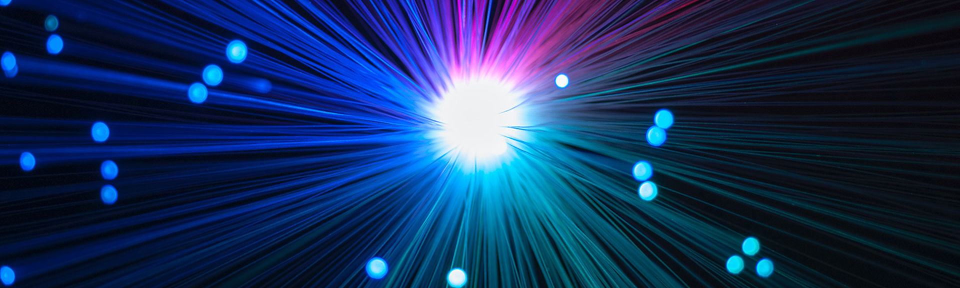 An abstract image showing orb of light emitting streaks of colour