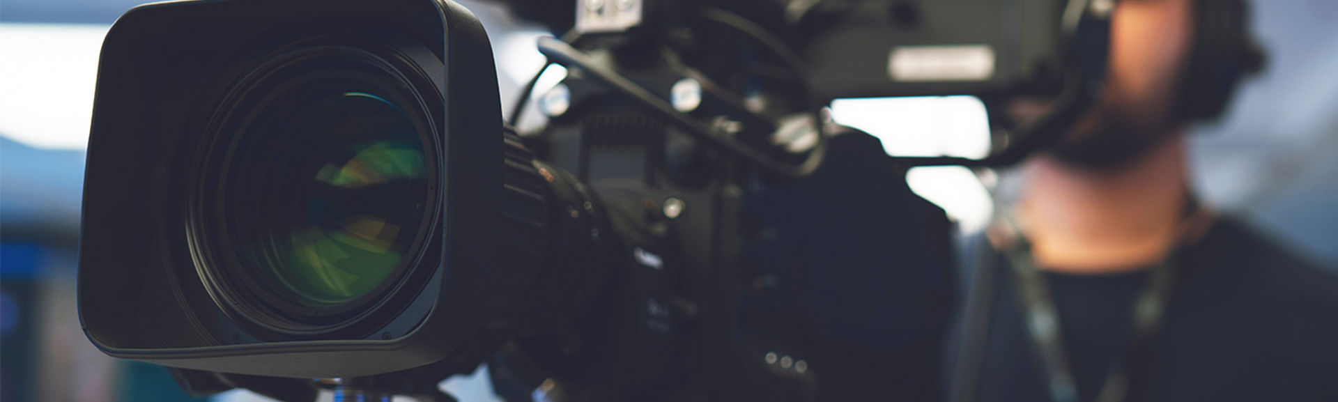 Professional cameraman with headphones with HD camcorder in live television