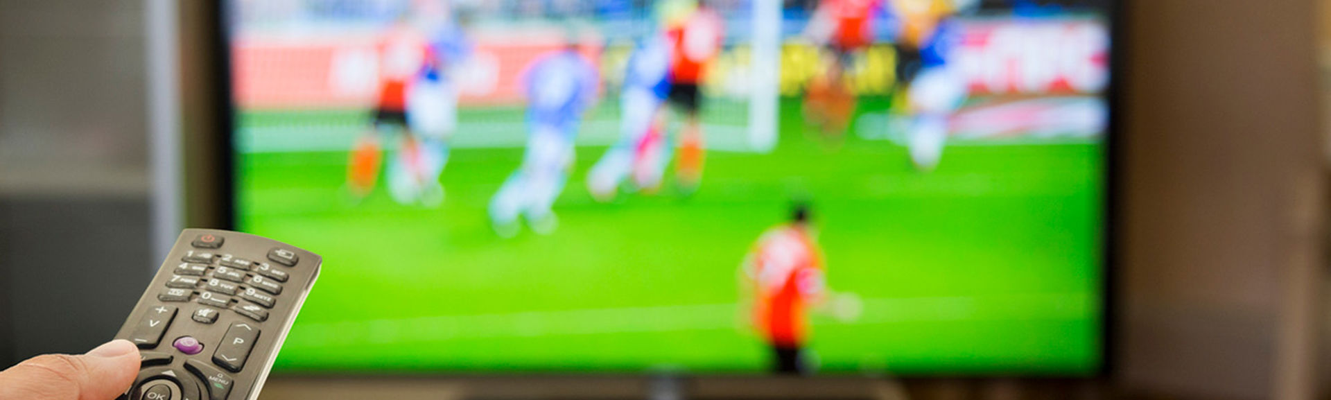 A football match being displayed on a television screen