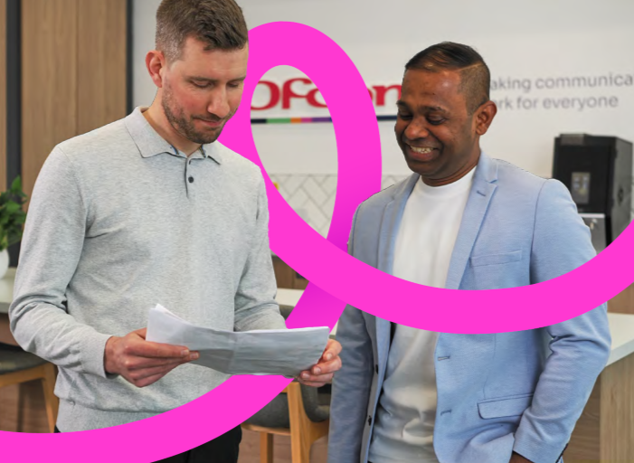Two Ofcom colleagues discussing their work
